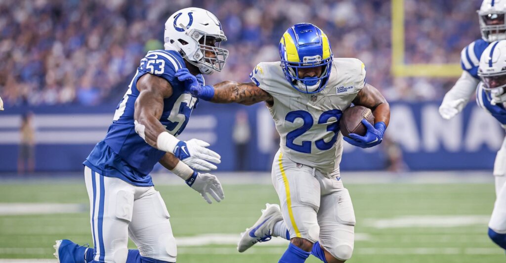 Picture of Kyren Williams stiff arming a defender on the field